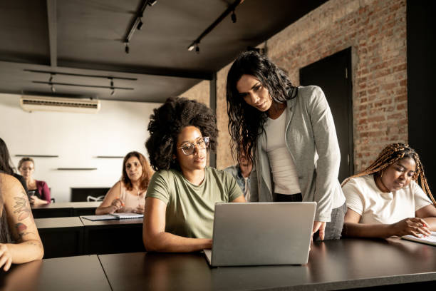 istock Transgender woman helping student in a classroom 1468068983