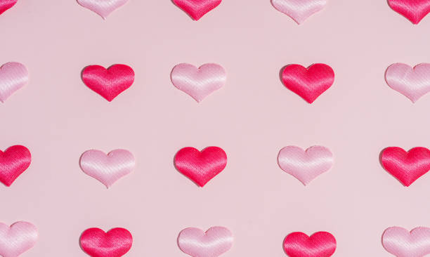 istock Background pattern pink and red heart on peach colored paper 1468069198