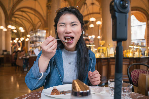 istock Asia travel vlogger introduce great menu famous restaurant while lives streaming for social reel video social media platform,Social media influencer online video of food at cafe, smartphone 1468075340