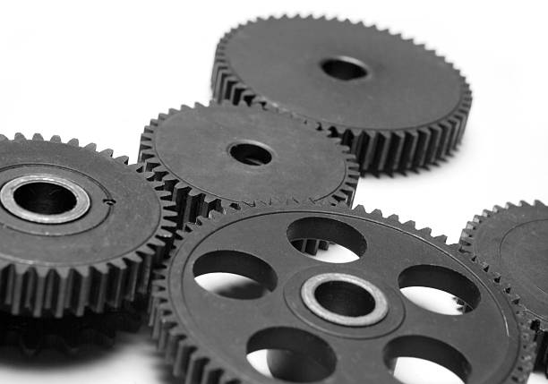 istock Black gears close up on white background 146807763