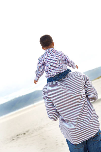 istock Small boy sitting on his fathers shoulders 146807789