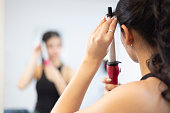 Woman using the ferro to comb her hair