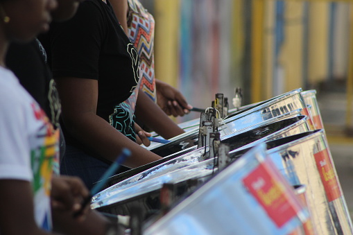 Port of Spain, Trinidad - January 29, 2023: A group of young women playing the steel pan on the streets of Port of Spain practicing for the carnival season