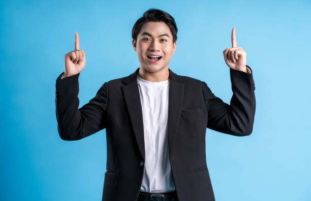 istock Young business man wearing a vest posing on a blue background 1468082933