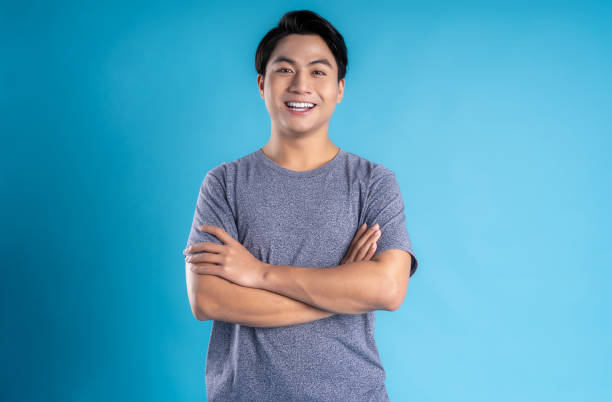 istock Asian young man posing on blue background 1468083495