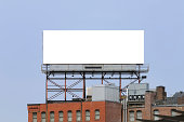 Large billboard on the top of a building in a city