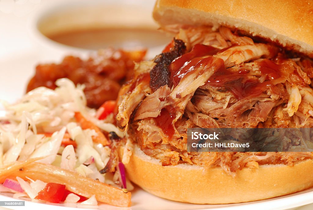 Pulled pork sandwich Barbecued pulled pork sandwich with coleslaw and baked beans Pulled Pork Stock Photo