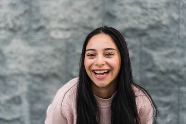 istock Laughing woman against gray background. 1468087552