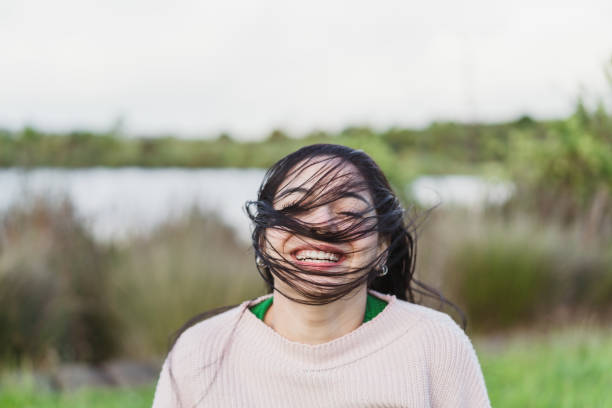 Young woman posing  with toothy smile outdoor.