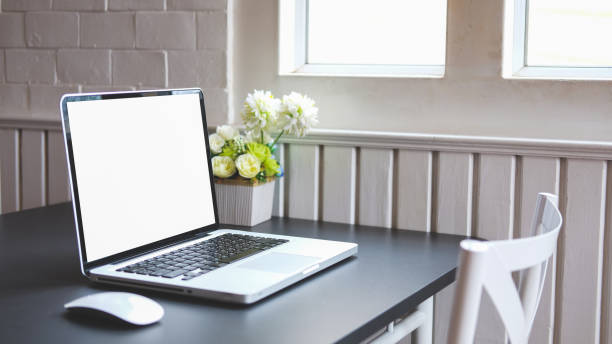 istock Comfortable workplace with laptop computer and potted plant on black wooden table. Blank screen for your advertise design. 1468089196