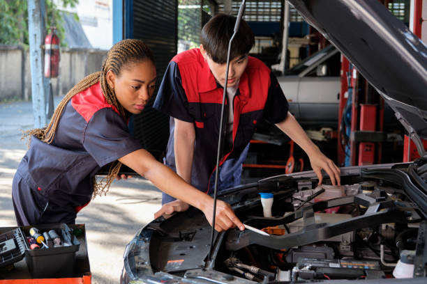istock Two automotive mechanical partners check an EV car at a fixing garage. 1468090513