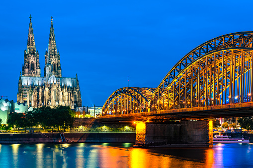 The Cologne Cathedral and Rhine river at night.