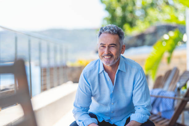 istock Mature man sitting on the balcony looking away. 1468106594