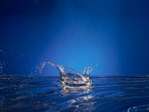 Close up of splashing water droplet. Blue Background