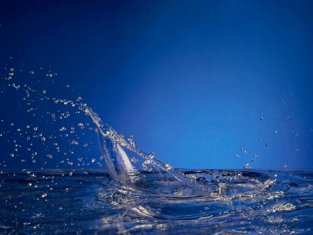 Close up of splashing water droplet. Blue Background