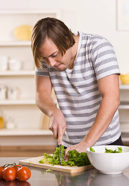 istock Attractive male cutting lettuce 146810942
