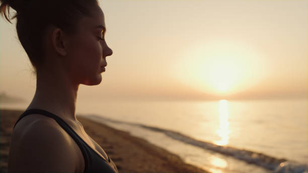 istock Profile sportswoman making meditation exercise on beach cposeup. Harmony concept 1468110189