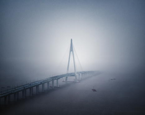 Hangzhou Bay Bridge is a highway bridge with two separate cable-stayed portions, built across the mouth of Hangzhou Bay in the eastern coastal region of China. It connects the municipalities of Jiaxing and Ningbo in Zhejiang province.