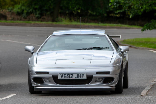 Turvey, Bedfordshire, UK - June 12th 2022.  1999 silver LOTUS ESPRIT V8 SPORT 350 car driving through an English village