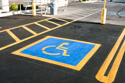 parking space reserved for handicapped shoppers in a retail parking lot.