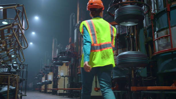 istock Back view engineer walking at manufacturing factory. Modern energy work concept. 1468117188