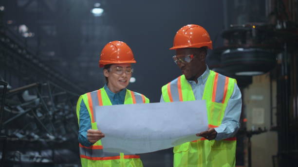 istock Professional partners holding paper plan manufacturing company project. 1468118883
