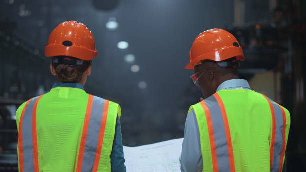istock Professional multiethnic supervisors walking at special factory warehouse. 1468118939