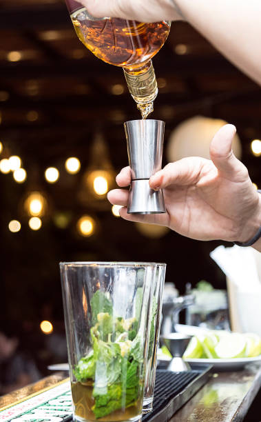 istock Bartender serving alcohol in a cocktail. Cocktail preparation in a night environment. It can be a hotel, a restaurant or a night club. 1468119711
