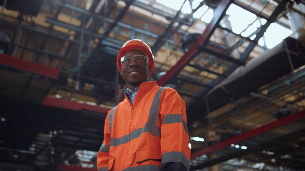 istock Cheerful professional looking camera at modern huge manufacturing warehouse. 1468119761
