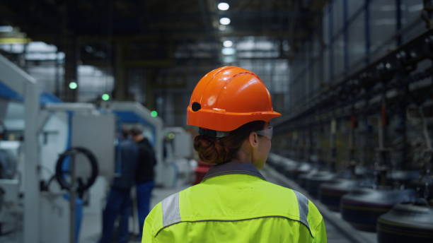 istock Back view mechanic walking plant. Huge industrial manufacturing modern warehouse 1468120777