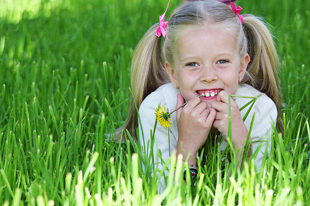 istock girl with dandelion 146812128
