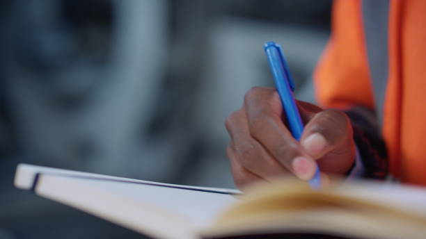 istock Analyst hands writing notes at factory closeup. Brown skin man use notebook 1468123302