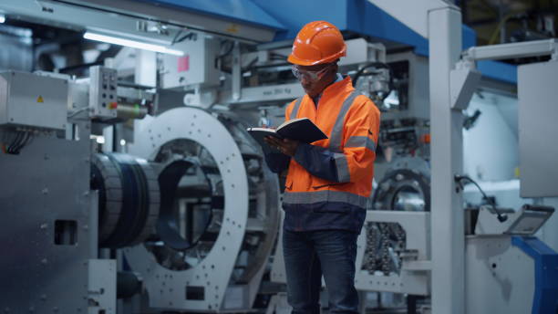 istock Male engineer taking notes of project data at manufacturing factory. 1468123469