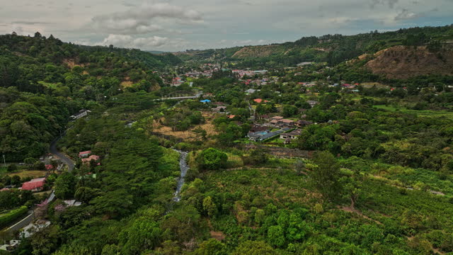 Boquete Panama Aerial v2 cinematic low level flyover capturing idyllic townscape of small mountain town along the caldera river, surrounded by chiriqui highlands - Shot with Mavic 3 Cine - April 2022