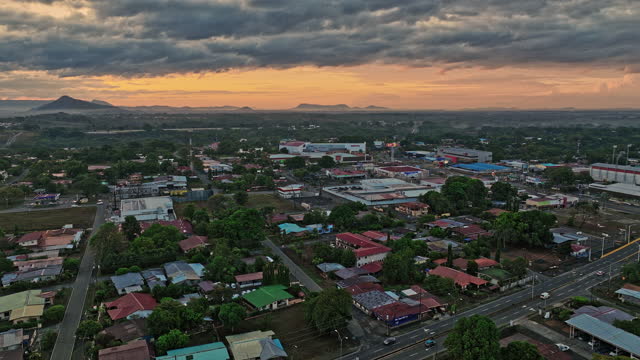 David Panama Aerial v7 low level flyover santa cruz neighborhood, panning capturing residential townscape and mountainscape at sunrise with glowing golden sky - Shot with Mavic 3 Cine - April 2022