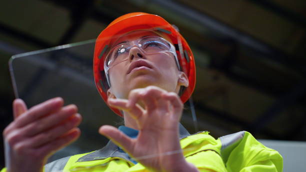 istock Woman specialist working project on transparent tablet computer at factory. 1468125149