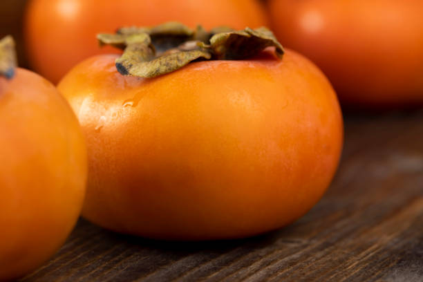 istock Whole ripe orange persimmon on the table 1468126210