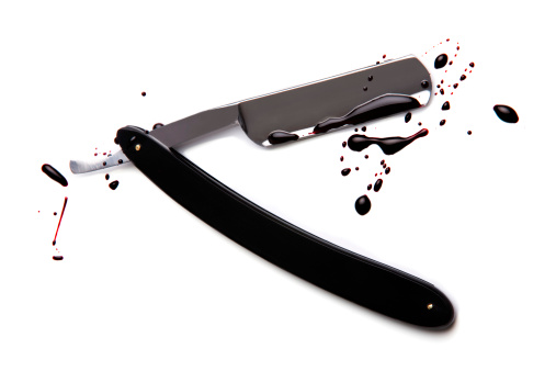 Bloodied cut-throat razor isolated on white background
