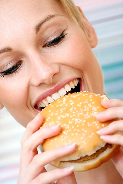istock young woman with hamburger 146812811