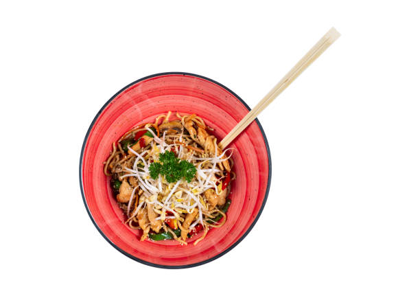 Noodles with vegetables on an isolated white background