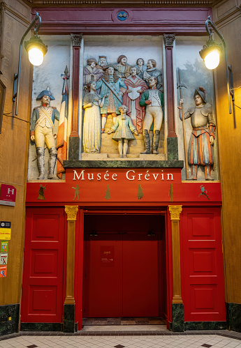 Paris, France - February 10 2023: Musee Grevin exit in Passage Jouffroy. This historic wax figures museum was opened in 1882.