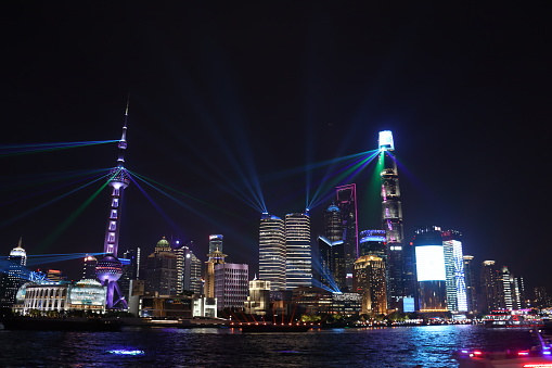 Laser show over Hong Kong cityscape at downtown modern building area at night