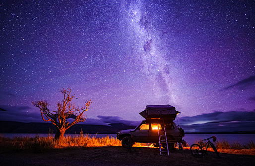 Starry night with backdrop of southern alps of New Zealand and beautiful Lake Ohau in South Island, New Zealand.
