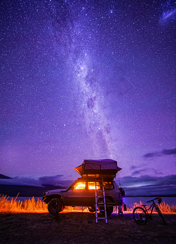 Starry night with backdrop of southern alps of New Zealand and beautiful Lake  Ohau in South Island, New Zealand.