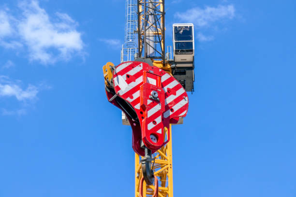 Red and White Striped Crane Chain block hoist with the steel cable attached to a construction crane on building site in Bondi Junction, Sydney.  This image was taken on a sunny morning in late summer. bondi junction stock pictures, royalty-free photos & images