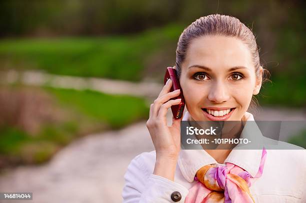 Chica En Abrigo Blanco Con Teléfono Foto de stock y más banco de imágenes de Abrigo - Abrigo, Actividades recreativas, Adulto