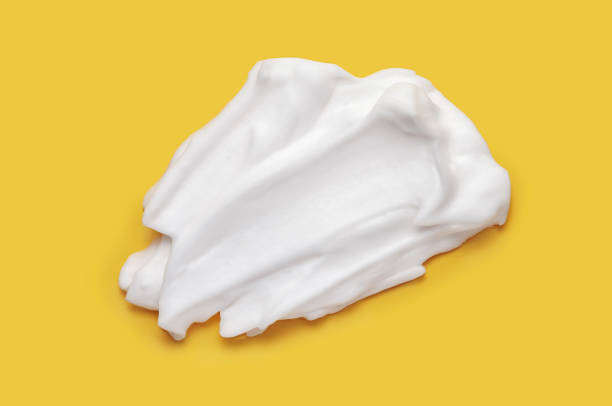 Shaving cream isolated on yellow color background. stock photo