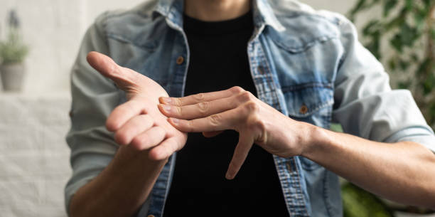 istock Sign language interpreter man translating a meeting to ASL, American Sign Language. Empty copy space for Editor's content 1468140778