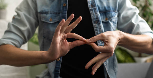 Sign language interpreter man translating a meeting to ASL, American Sign Language. Empty copy space for Editor's content