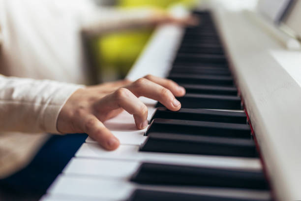 istock Child practicing on the modern electric piano at home. 1468141141